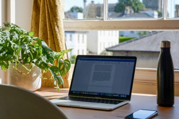 macbook pro on brown wooden table