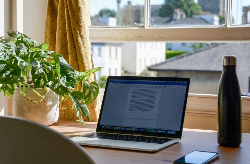 macbook pro on brown wooden table