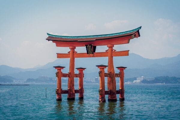 red shrine in body of water