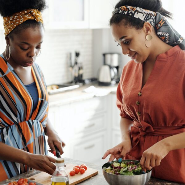 Two friends are preparing food for Friendsgiving.