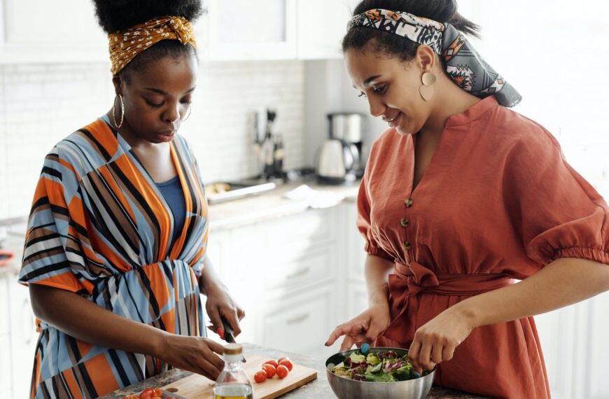 Two friends are preparing food for Friendsgiving.