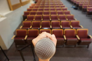 A hand gripping a microphone 