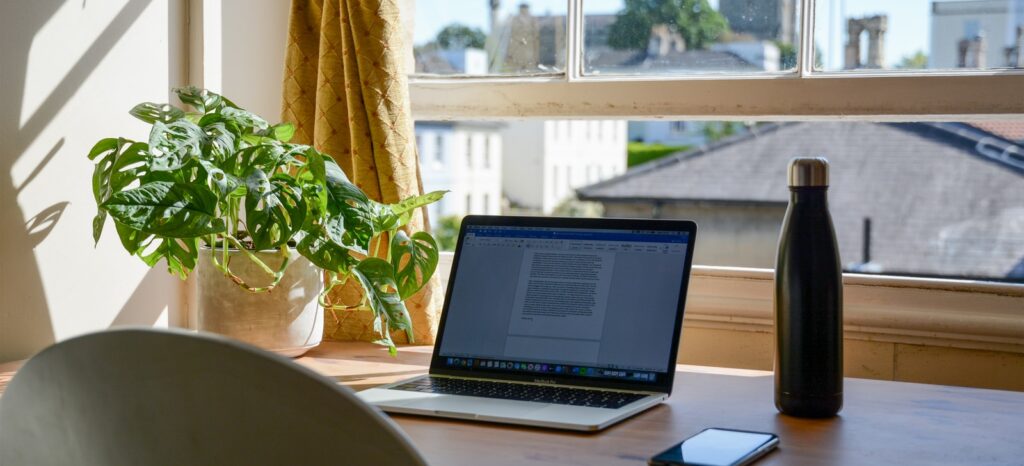 macbook pro on brown wooden table